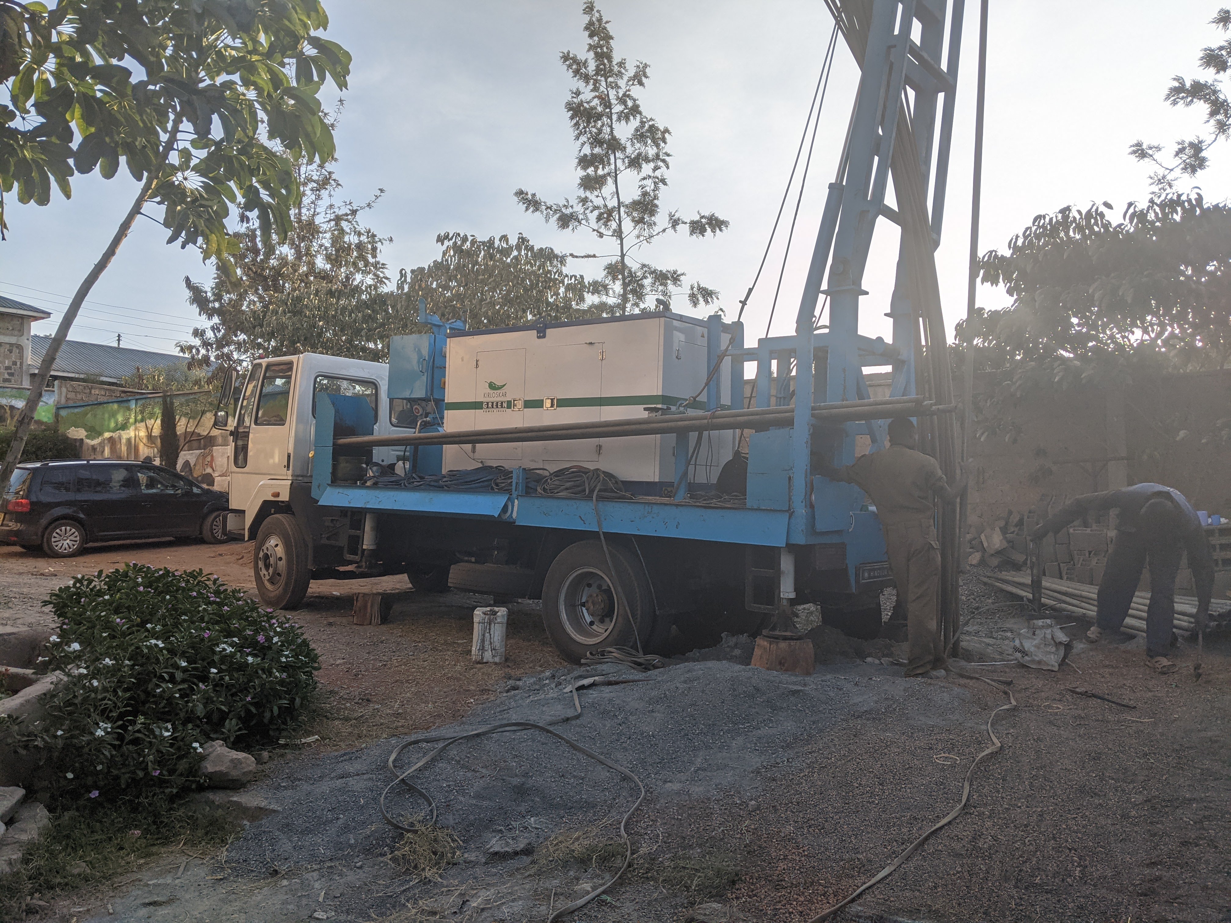 Completed borehole with pump and water flowing